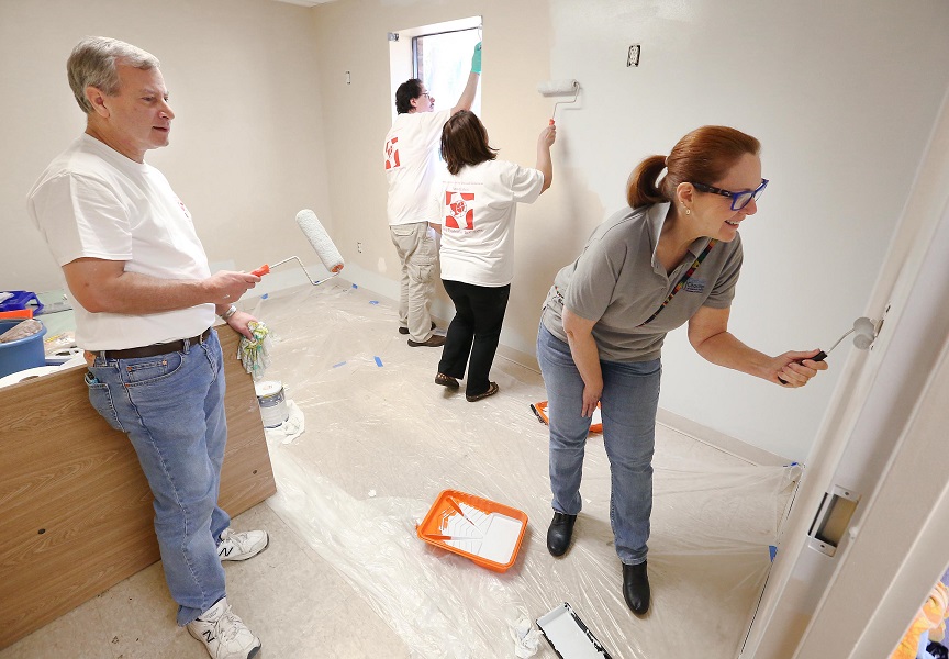 Volunteers refurbishing resident room